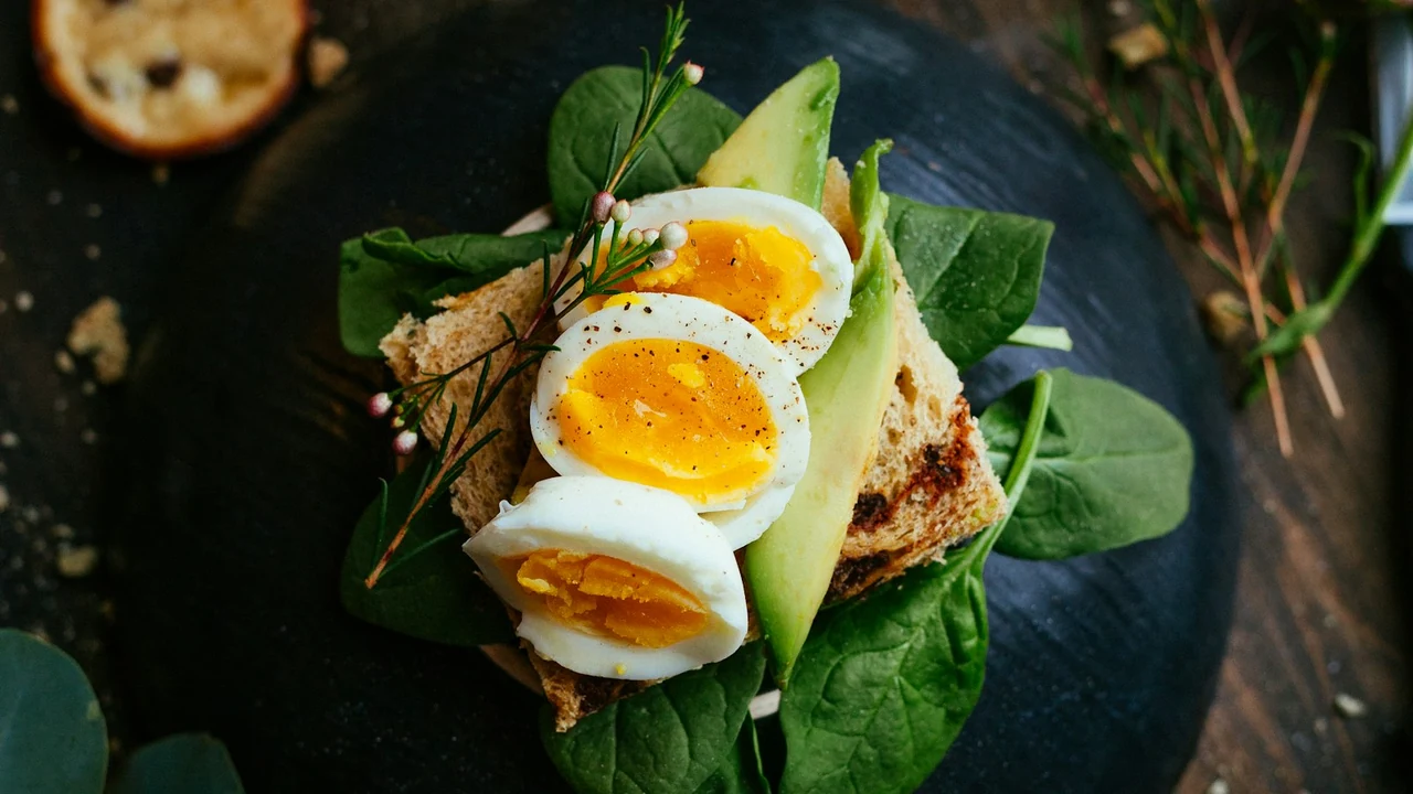 Nutritious poached egg on a balanced breakfast plate with greens and whole grains