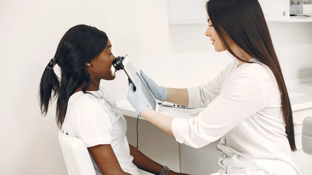 Dermatologist conducting optical skin analysis on patient in modern clinic setting