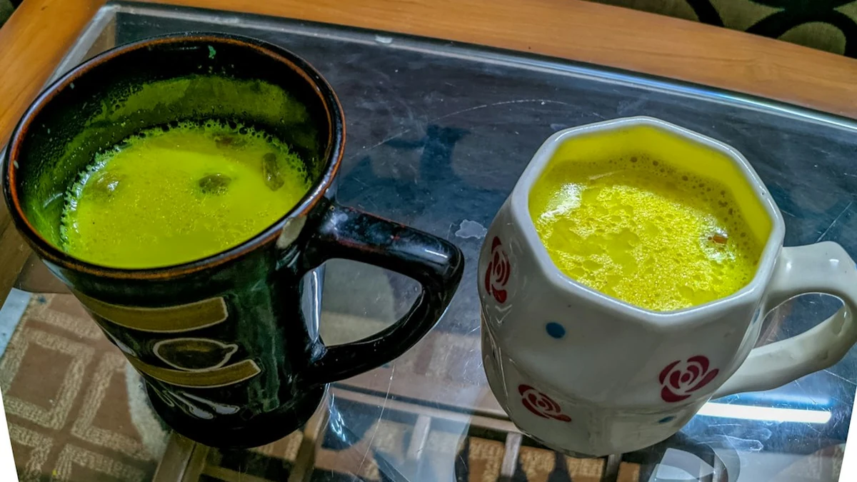 Freshly brewed mugs of golden turmeric milk ready to drink