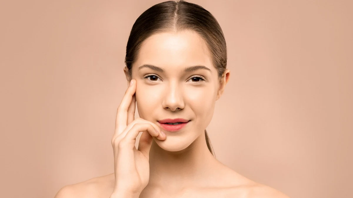 Close-up portrait of woman with clear radiant skin and natural healthy complexion