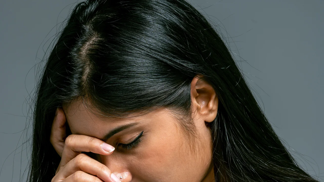 Person experiencing peaceful relaxation and mental de-stressing during a calming therapeutic massage session