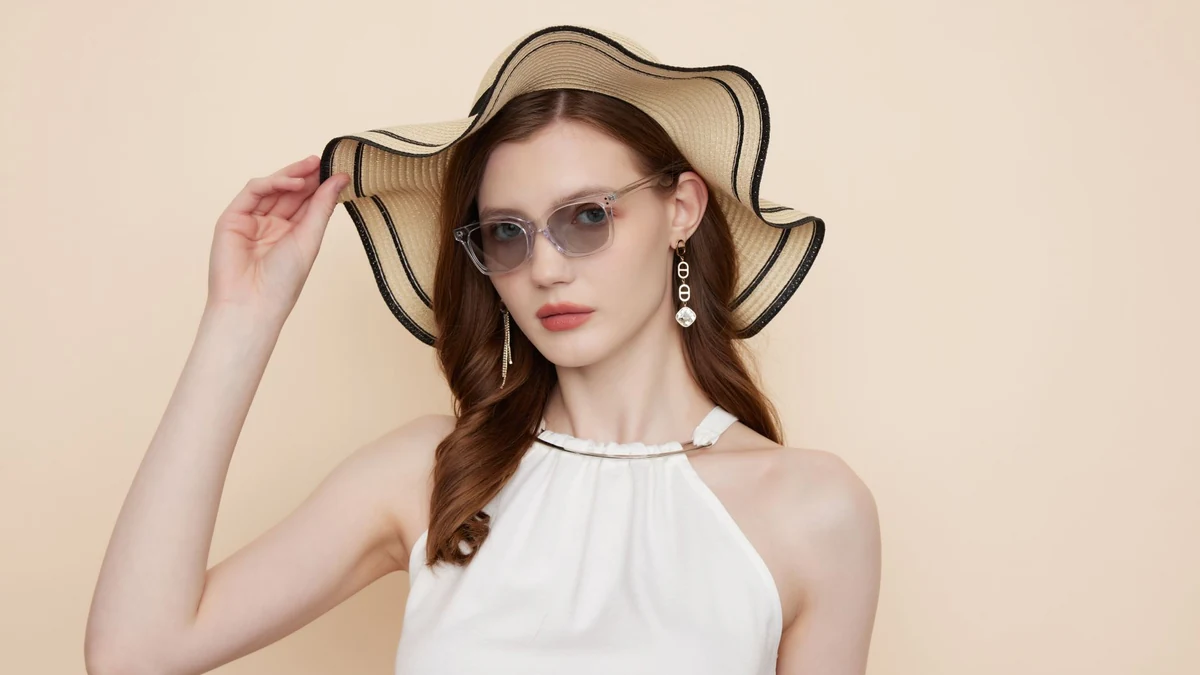 Stylish woman wearing UV sunglasses and wide-brim hat for outdoor physical sun protection