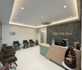 Modern front desk with warm lighting and patient seating at Dermis 365